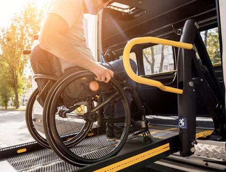 Man entering a car in a wheel chair