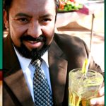 Business man smiling holding drink