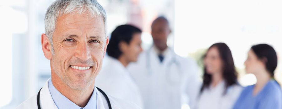 doctor smiling with doctors in background